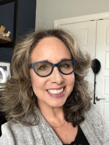 Allison Crow Smiling at 49 in her office 