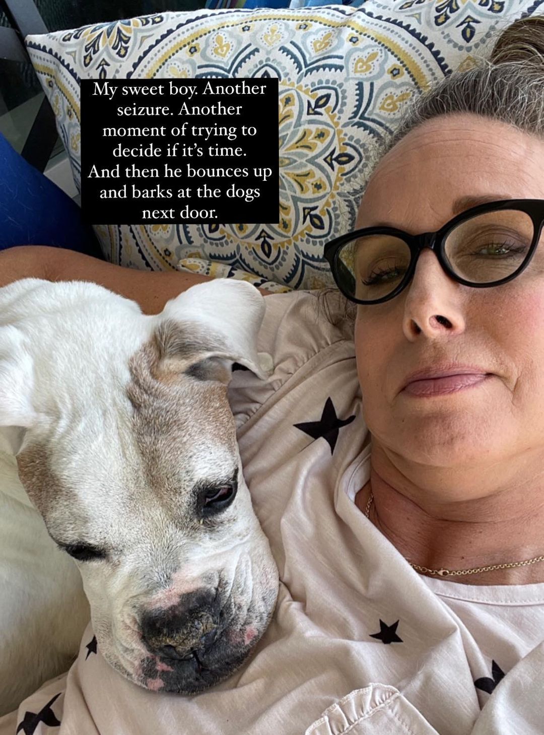 Allison with old white dog resting his head on her chest.