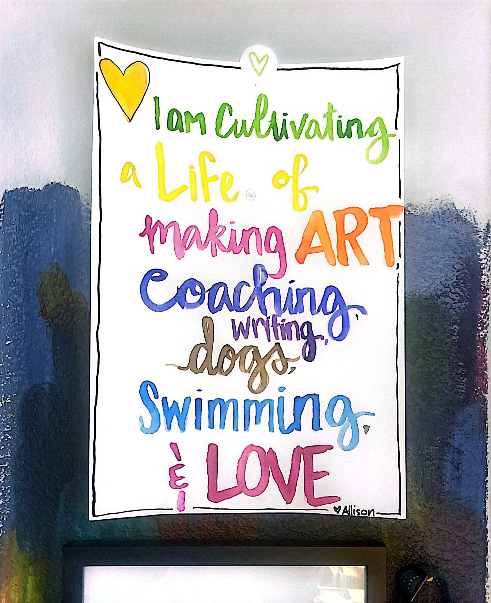 A hand painted poster that says I am cultivating a life of making art, coaching, wriring, dogs, swimming, and love. by Allison. 